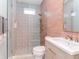 Modern bathroom with decorative tile, glass shower, and light wood vanity with gold fixtures at 4612 W Lowell Ave, Tampa, FL 33629