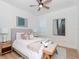 Serene bedroom with ceiling fan, light color scheme, and a bench at the end of the bed at 4612 W Lowell Ave, Tampa, FL 33629