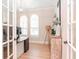 Bright office featuring french door entry, arched windows with plantation shutters, and wood-look flooring at 4612 W Lowell Ave, Tampa, FL 33629