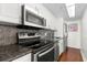 Updated kitchen with stainless steel appliances, sleek granite counters, and dark wood floors at 470 3Rd S St # 814, St Petersburg, FL 33701