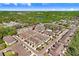 Wide aerial view of townhome community with community pool, pond, and mature trees at 5034 Blue Latan Ln, Tampa, FL 33610