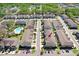 Aerial view of townhome community with parking and landscaping at 5034 Blue Latan Ln, Tampa, FL 33610