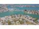 Expansive aerial shot featuring waterfront homes, clear waters, bridge access, and the neighborhood's desirable coastal living at 55 Dolphin Dr # A, Treasure Island, FL 33706