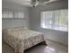 Cozy bedroom with a comfortable bed, a ceiling fan, and large windows for natural light at 55 Dolphin Dr # A, Treasure Island, FL 33706