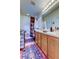 Well-lit bathroom featuring a shower-tub combo and vanity with wood cabinets at 565 52Nd N Ave, St Petersburg, FL 33703
