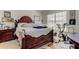 Comfortable bedroom with a decorative bed, large window, and functional workout machine creating a personal retreat at 565 52Nd N Ave, St Petersburg, FL 33703