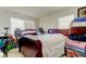 Bright bedroom with natural light and furnishings; needs decluttering at 565 52Nd N Ave, St Petersburg, FL 33703
