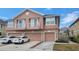 Charming townhouse featuring a stone facade, individual garages, and quaint balconies on the second level at 565 52Nd N Ave, St Petersburg, FL 33703