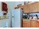 Efficient kitchen featuring white appliances, light wood cabinets, and functional layout, ideal for meal preparation and storage at 565 52Nd N Ave, St Petersburg, FL 33703