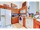 Functional kitchen featuring white appliances, light wood cabinetry, and ample counter space for culinary endeavors at 565 52Nd N Ave, St Petersburg, FL 33703