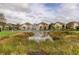 Community pond view with fountain surrounded by well-maintained homes at 565 52Nd N Ave, St Petersburg, FL 33703