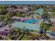 Aerial view of the community clubhouse and pool area surrounded by mature landscaping and palm trees at 6125 113Th St # 505, Seminole, FL 33772