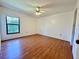 Bright bedroom featuring wood floors, a ceiling fan, and a window for natural light at 6125 113Th St # 505, Seminole, FL 33772
