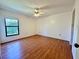 Bright bedroom featuring wood floors, a ceiling fan, and a window for natural light at 6125 113Th St # 505, Seminole, FL 33772