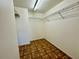 Walk-in closet features patterned floors and built-in shelving for optimal storage at 6125 113Th St # 505, Seminole, FL 33772