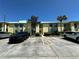Exterior view of the condo building with parking and landscaping at 6125 113Th St # 505, Seminole, FL 33772