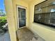 Close-up of the front door and window with a view of the parking area at 6125 113Th St # 505, Seminole, FL 33772