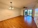 Living room with wood floors and a sliding glass door to the lanai at 6125 113Th St # 505, Seminole, FL 33772