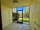 Enclosed patio with tiled flooring, offering a view of the lush green yard at 6125 113Th St # 505, Seminole, FL 33772
