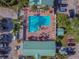 Overhead aerial shot of the pool and sundeck area, complete with lounge chairs and palm trees at 6125 113Th St # 505, Seminole, FL 33772