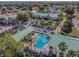 Aerial view of a community pool surrounded by palm trees and a sun deck at 6125 113Th St # 505, Seminole, FL 33772