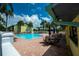 Community pool surrounded by lounge chairs and patio tables for relaxing poolside at 6125 113Th St # 505, Seminole, FL 33772