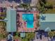 Overhead aerial shot of the pool and sundeck area, complete with lounge chairs and palm trees at 6125 113Th St # 505, Seminole, FL 33772