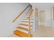 Staircase with wooden handrail, painted risers, and tile flooring leading to the next level at 614 Vanderbaker Rd, Temple Terrace, FL 33617