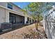 The backyard patio with screens and AC unit with a white picket fence at 708 Barclay Wood Dr, Ruskin, FL 33570