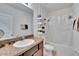 Bathroom featuring single sink vanity, shower with tub, and neutral tile flooring at 708 Barclay Wood Dr, Ruskin, FL 33570