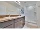Bathroom features a double sink vanity with modern fixtures and a separate shower area at 708 Barclay Wood Dr, Ruskin, FL 33570