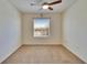 A bedroom featuring neutral carpeting, a ceiling fan, and a window with horizontal blinds at 708 Barclay Wood Dr, Ruskin, FL 33570