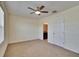Neutral bedroom has carpet, ceiling fan, and doorway to bathroom at 708 Barclay Wood Dr, Ruskin, FL 33570