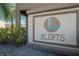 The Lofts community sign with modern logo and landscaping in a well-maintained neighborhood at 708 Barclay Wood Dr, Ruskin, FL 33570
