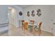 Cozy dining area featuring a glass-top table, seating for four, and decorative wall art at 708 Barclay Wood Dr, Ruskin, FL 33570