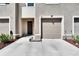 Beige townhouse featuring a one car garage, front door, rock landscaping and a well maintained lawn at 708 Barclay Wood Dr, Ruskin, FL 33570