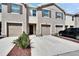 Beige two-story townhouse featuring a one car garage, front door, rock landscaping and a well maintained lawn at 708 Barclay Wood Dr, Ruskin, FL 33570