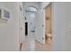 Hallway with tile flooring, access to bathroom, arched doorway, and white trim at 708 Barclay Wood Dr, Ruskin, FL 33570