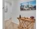 Hallway with light wood table, decorations, and white walls with carpet flooring at 708 Barclay Wood Dr, Ruskin, FL 33570