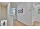 Bright hallway featuring neutral paint, carpet flooring, and decorative wall art at 708 Barclay Wood Dr, Ruskin, FL 33570