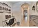 Well-lit hallway features tile flooring, decor and office nook with desk and chair at 708 Barclay Wood Dr, Ruskin, FL 33570