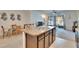 Open concept kitchen with island, stone countertops and stainless steel sink, opens to dining and living spaces at 708 Barclay Wood Dr, Ruskin, FL 33570