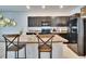 Well-lit kitchen features dark cabinets, stainless steel appliances, and bar stool seating at 708 Barclay Wood Dr, Ruskin, FL 33570