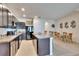 Spacious kitchen featuring an island with a sink, stainless appliances, and an adjacent dining area at 708 Barclay Wood Dr, Ruskin, FL 33570