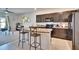 Modern kitchen with dark cabinets, stainless steel appliances, and a breakfast bar with seating at 708 Barclay Wood Dr, Ruskin, FL 33570