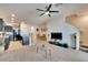Open concept living space with kitchen island, adjacent dining area, and neutral carpeting at 708 Barclay Wood Dr, Ruskin, FL 33570
