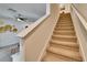 Carpeted staircase with white banister leading to the upper level of the home at 708 Barclay Wood Dr, Ruskin, FL 33570