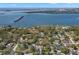Picturesque aerial shot of homes, mature trees, and tranquil bay waters meeting the distant city skyline at 8236 36Th N Ave, St Petersburg, FL 33710