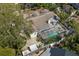 Aerial view of a home with a screened in pool, lush landscaping, and a spacious yard at 8236 36Th N Ave, St Petersburg, FL 33710