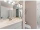 Well-lit bathroom featuring a vanity with mirrored medicine cabinet, toilet, and glass door shower at 8236 36Th N Ave, St Petersburg, FL 33710